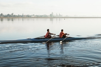 two people rowing in a boat